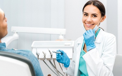 A female dentist checking a patient’s mouth