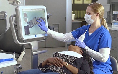 Dentist and patient looking at digital impressions