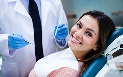 A young woman smiling in the dentist’s chair as she prepares for IV Sedation in Allen
