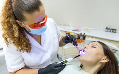 A patient under IV Sedation while a dentist performs dental work on their mouth