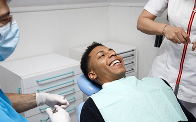 A male patient smiling as he prepares to undergo IV Sedation