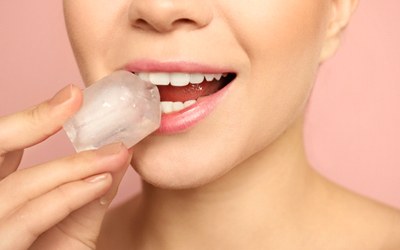 A woman biting a piece of ice