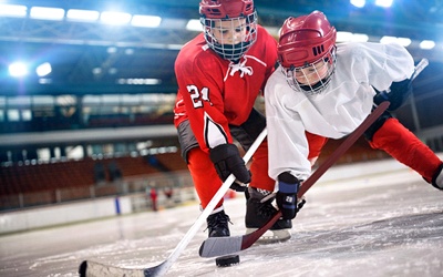 Two young boys playing hockey