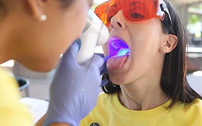 Woman receiving oral cancer screening