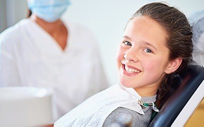 Child in dental chair smiling