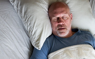 Man sleeping soundly in bed