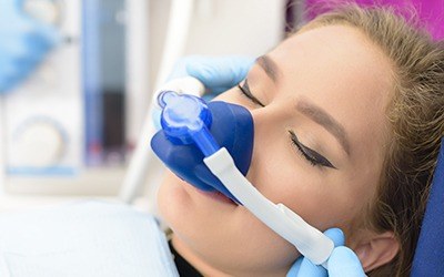 Woman with nitrous oxide nose mask